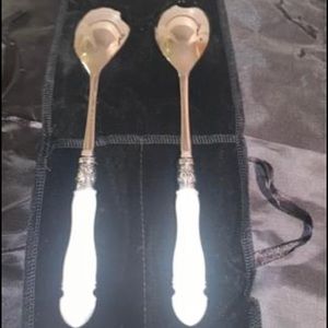 Silver and white ceramic serving utensils. SLAH